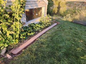 Textured curbing to separate lawn and flower beds