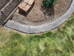 Textured curbing installed on corner of shrub beds