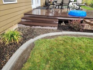 Curbing installed to separate rock garden, shrubs and lawn
