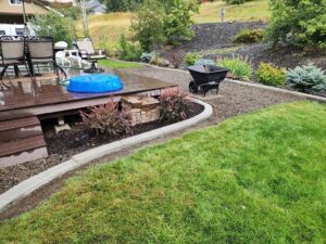 Rapid Curbing installed around deck and to separate shrubs and lawn